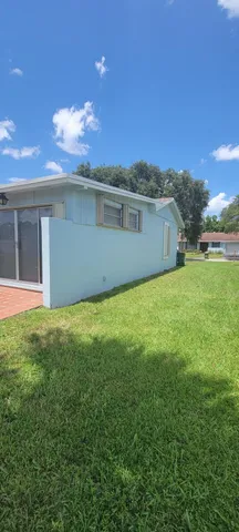 a view of house with yard and entertaining space