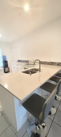 a view of kitchen and empty room