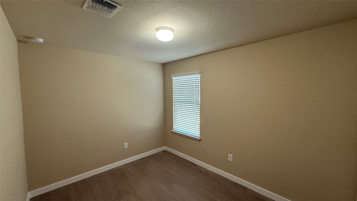 804 Red Tails Drive Austin, TX 78725 - Photo 11 of 14 an empty room with windows