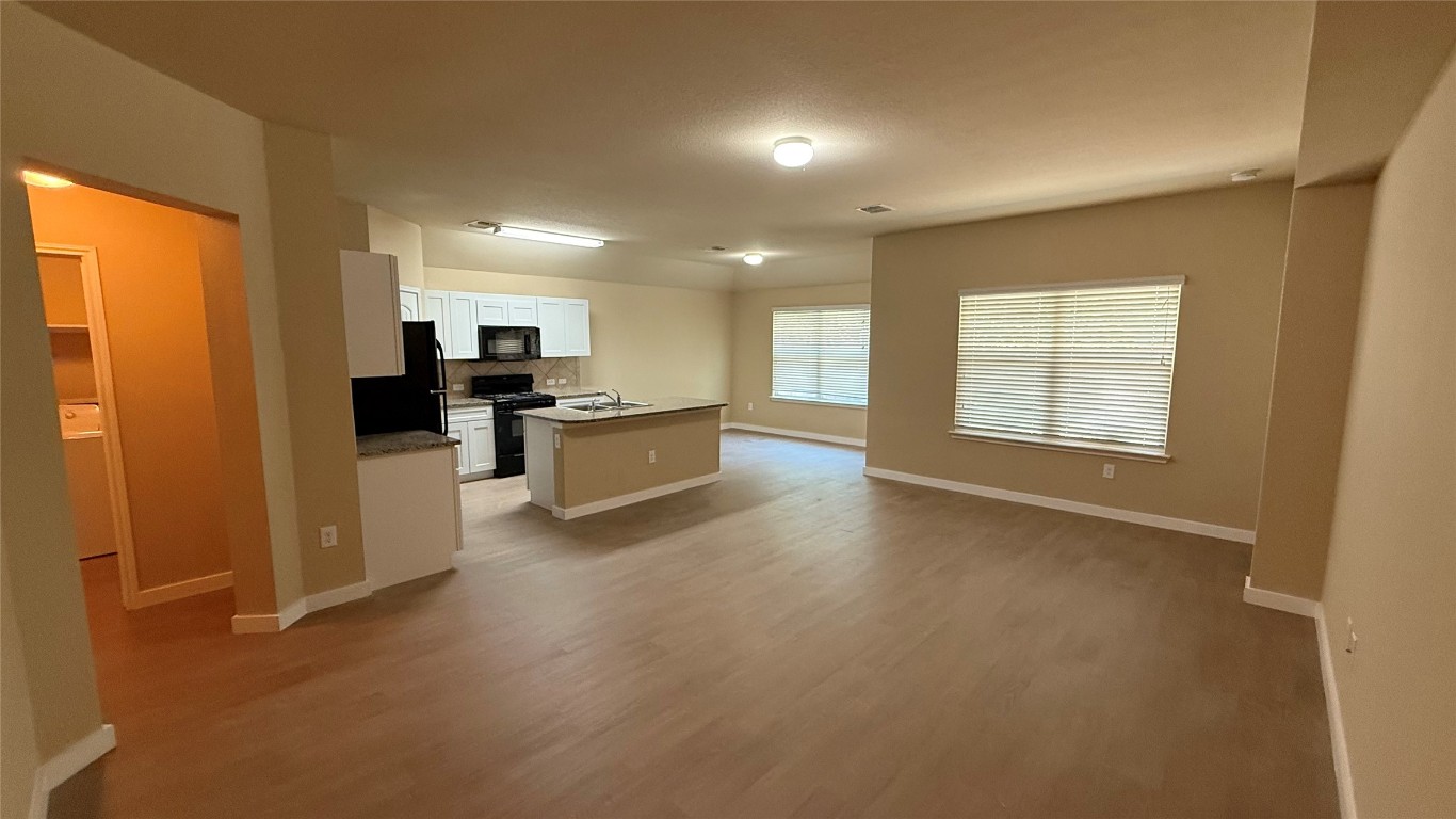 804 Red Tails Drive Austin, TX 78725 - Photo 4 of 14 a view of a kitchen with a sink cabinets and a window