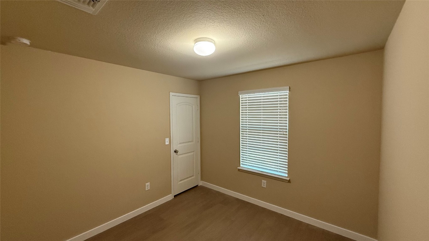804 Red Tails Drive Austin, TX 78725 - Photo 10 of 14 an empty room with windows