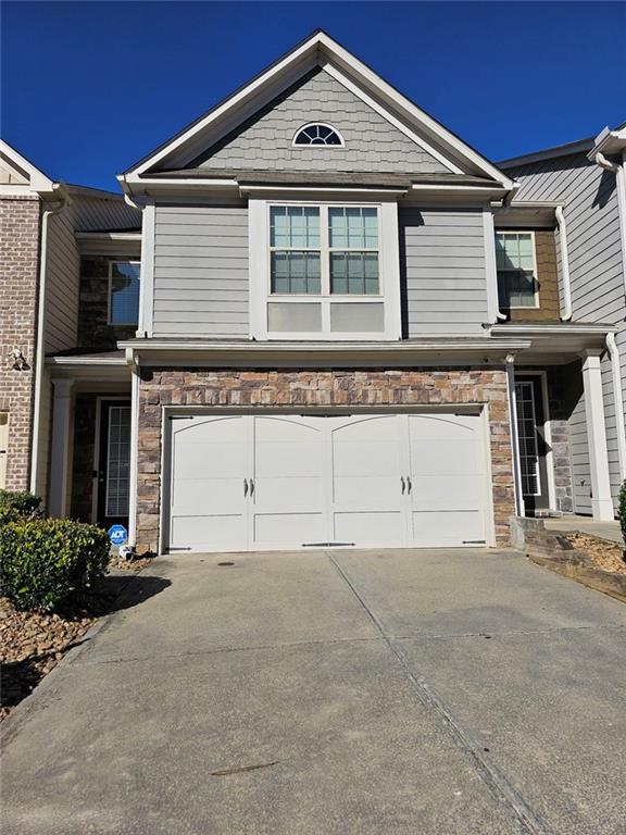 a front view of a house with garage
