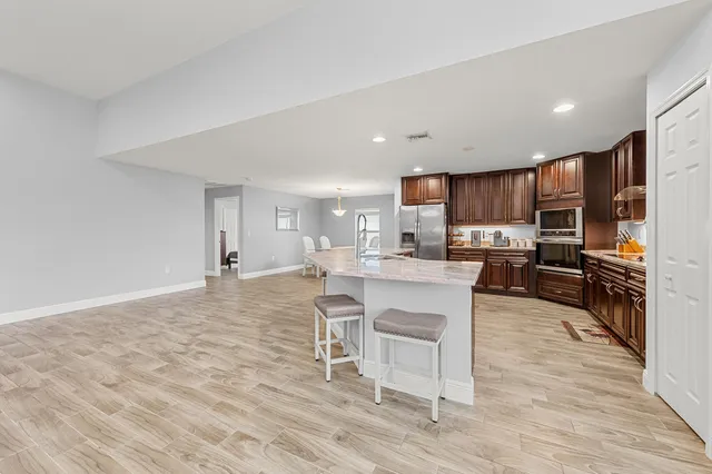 a kitchen with a sink cabinets and wooden floor
