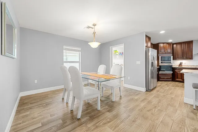 a view of a dining room with furniture and wooden floor