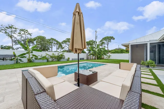 a view of a patio with a table and chairs