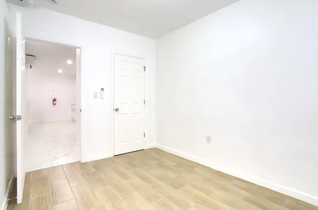 a view of a stone house with a bench