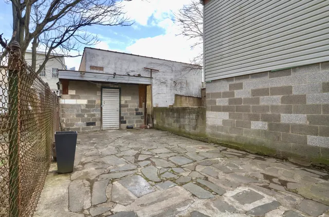 a view of a brick building next to a yard