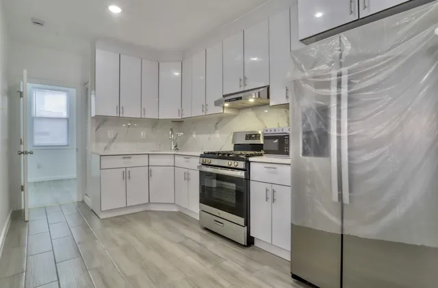 a kitchen with stainless steel appliances and wooden cabinets