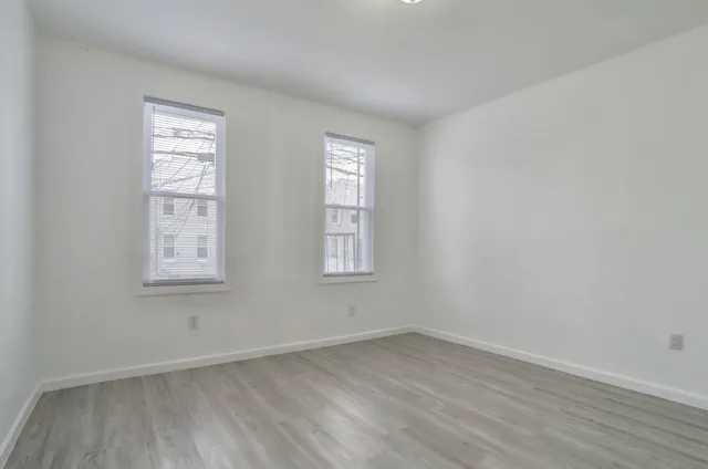 a view of an empty room and wooden floor