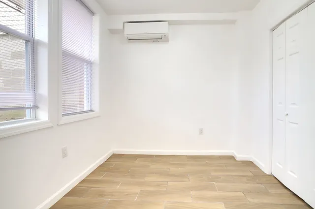 an empty room with wooden floor