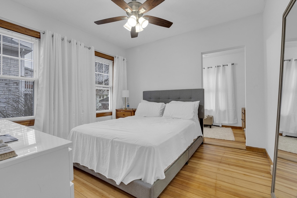 64 Commonwealth Road Watertown, MA 02472 - Photo 12 of 23 a large bed sitting in a bedroom next to a window and a chandelier