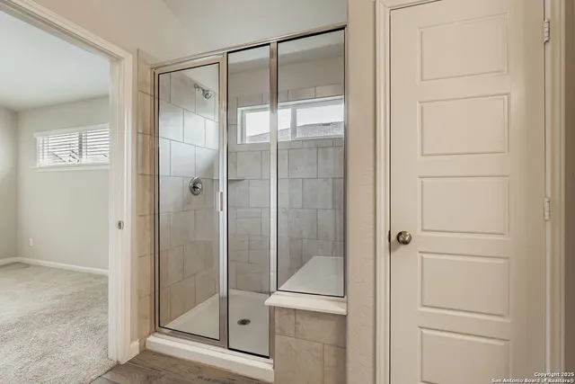 a bathroom with a glass shower door