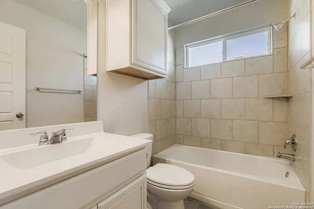 a bathroom with a sink a toilet and bathtub