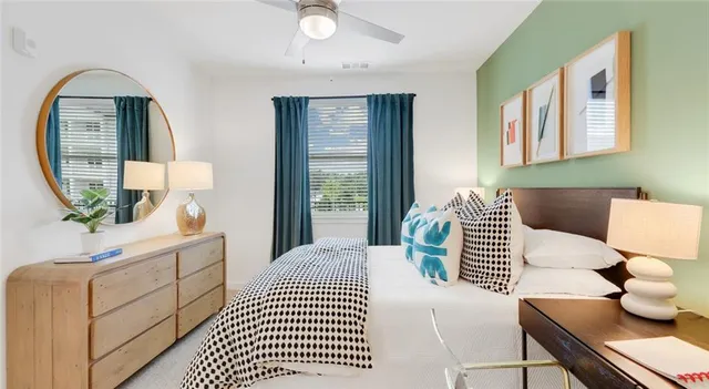 a bedroom with a large bed and a window