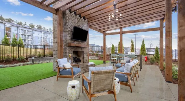 a view of a patio with dining table and chairs with a garden