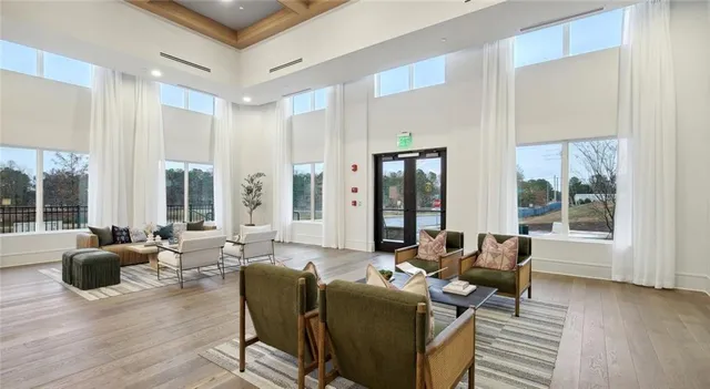 a living room with furniture and large windows