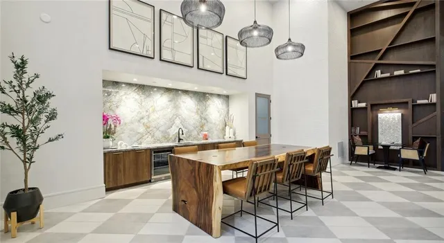 a kitchen with stainless steel appliances kitchen island granite countertop a table and chairs in it