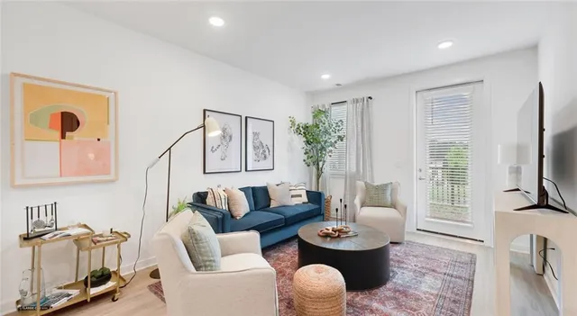a living room with furniture a rug and a flat screen tv