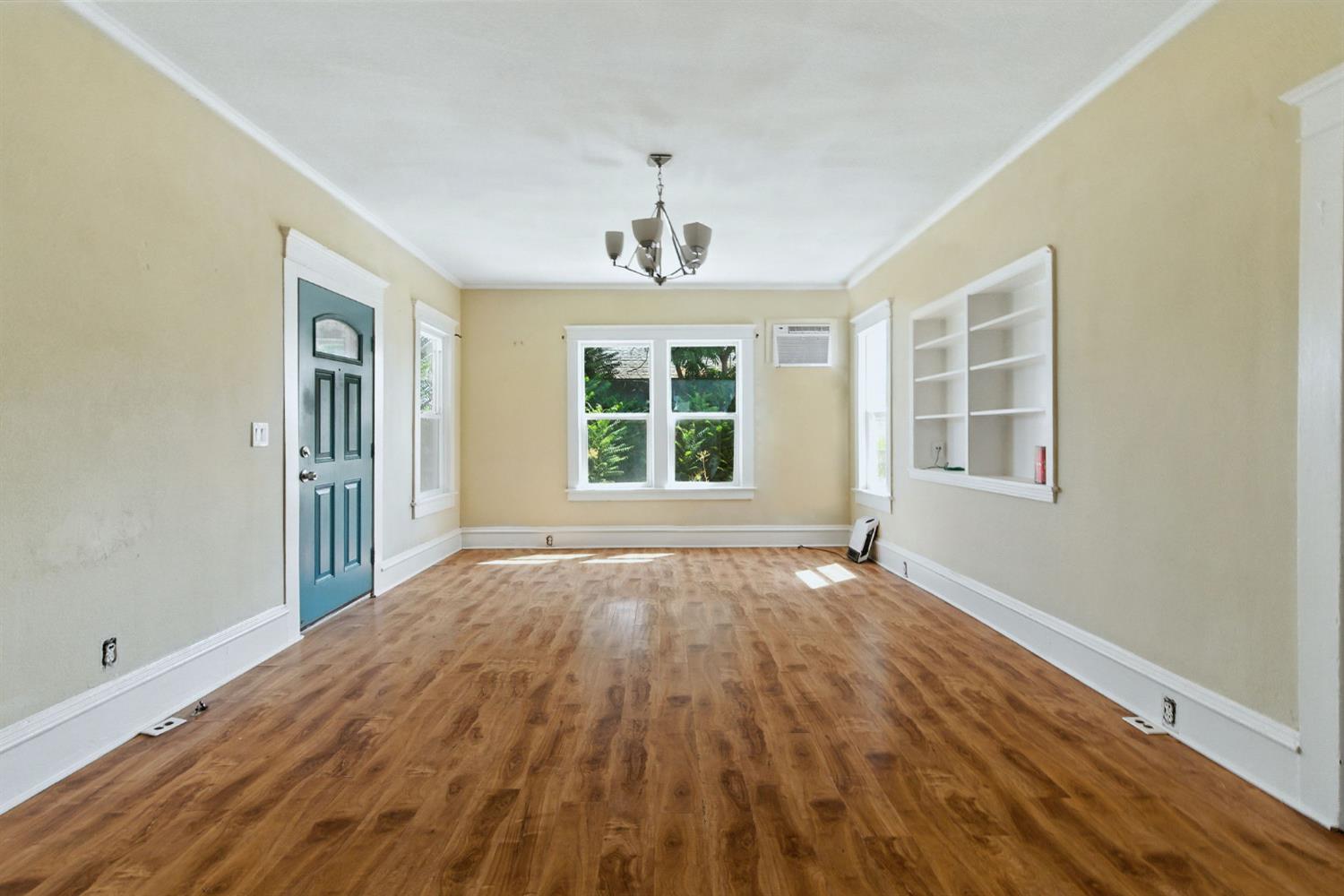312 West Main Street Turlock, CA 95380 - Photo 12 of 84 a view of an empty room with wooden floor and windows