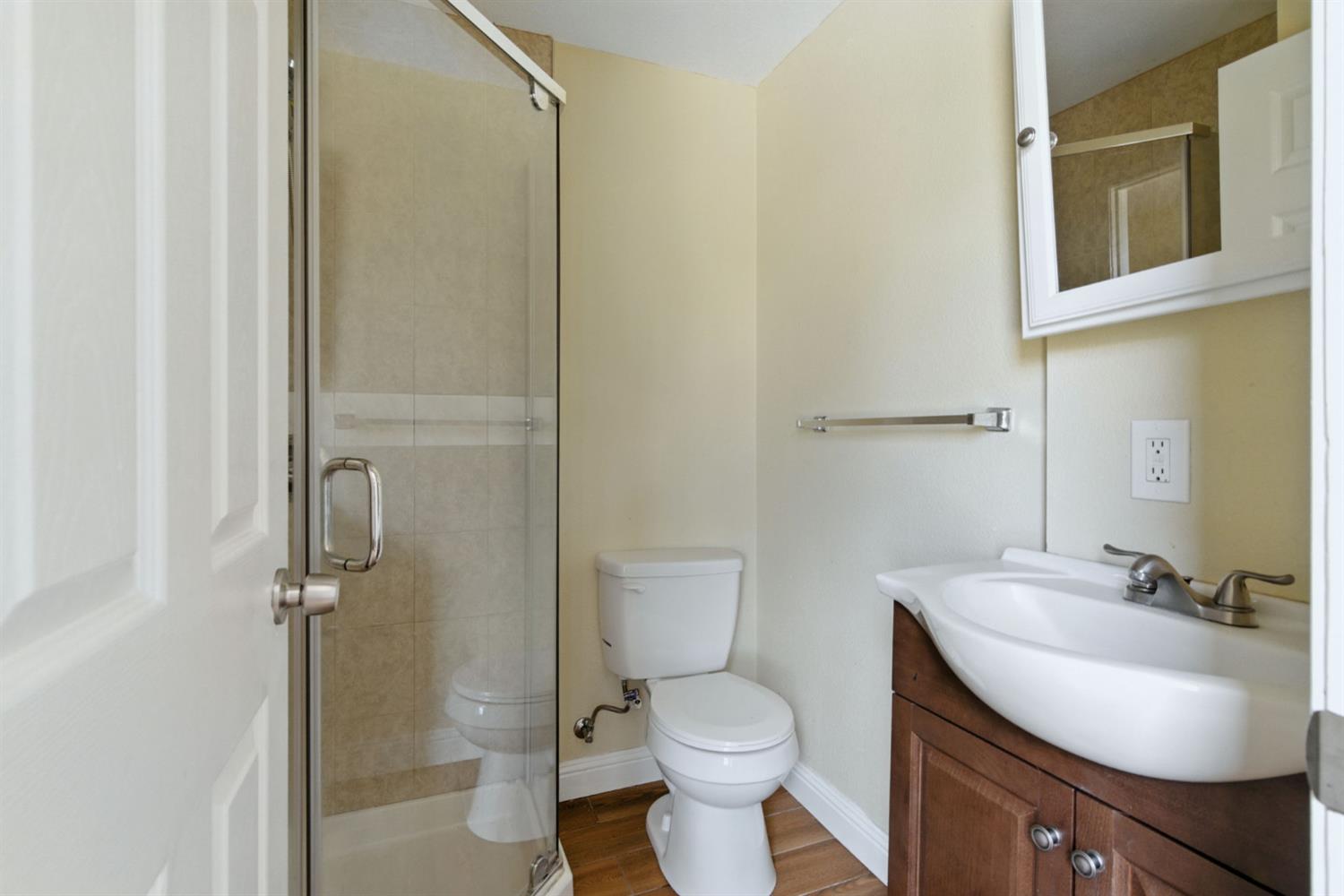 312 West Main Street Turlock, CA 95380 - Photo 20 of 84 a bathroom with a sink toilet and shower