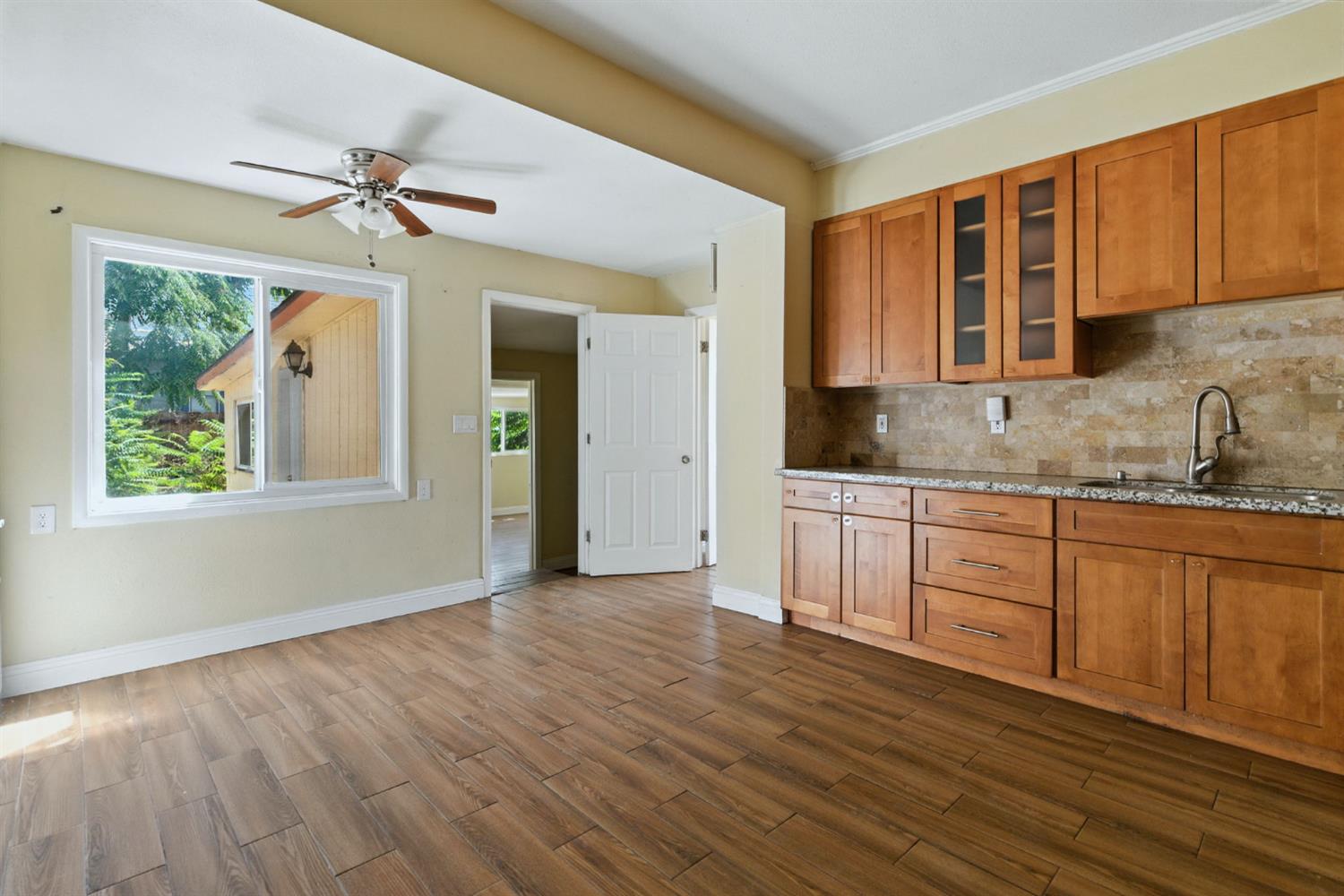 312 West Main Street Turlock, CA 95380 - Photo 23 of 84 a kitchen with stainless steel appliances granite countertop a sink cabinets and wooden floor