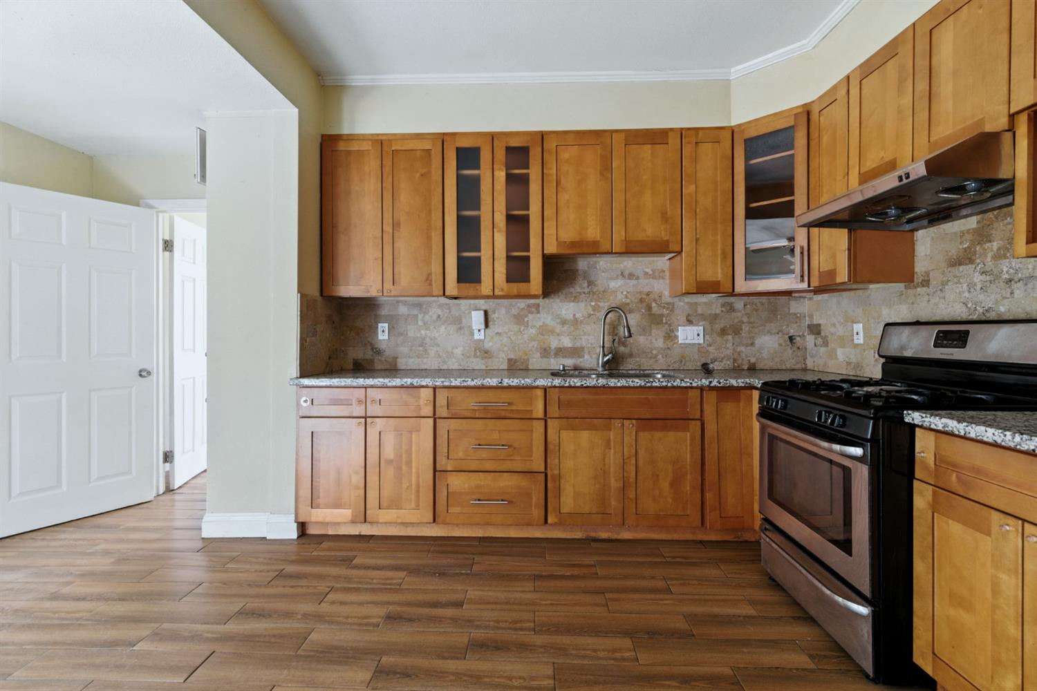 312 West Main Street Turlock, CA 95380 - Photo 24 of 84 a kitchen with stainless steel appliances granite countertop a stove a sink and a microwave