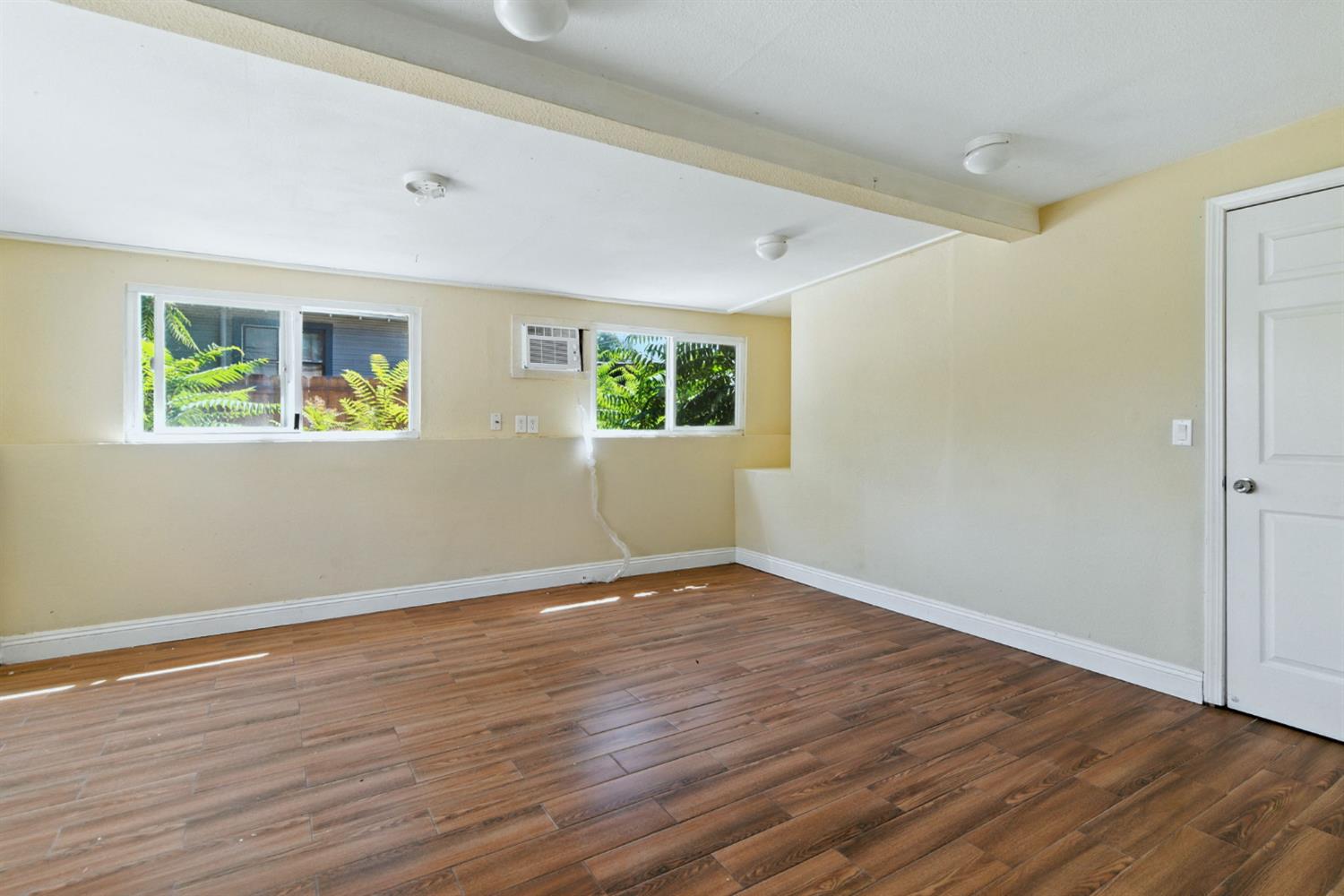 312 West Main Street Turlock, CA 95380 - Photo 30 of 84 a view of an empty room with wooden floor and a window