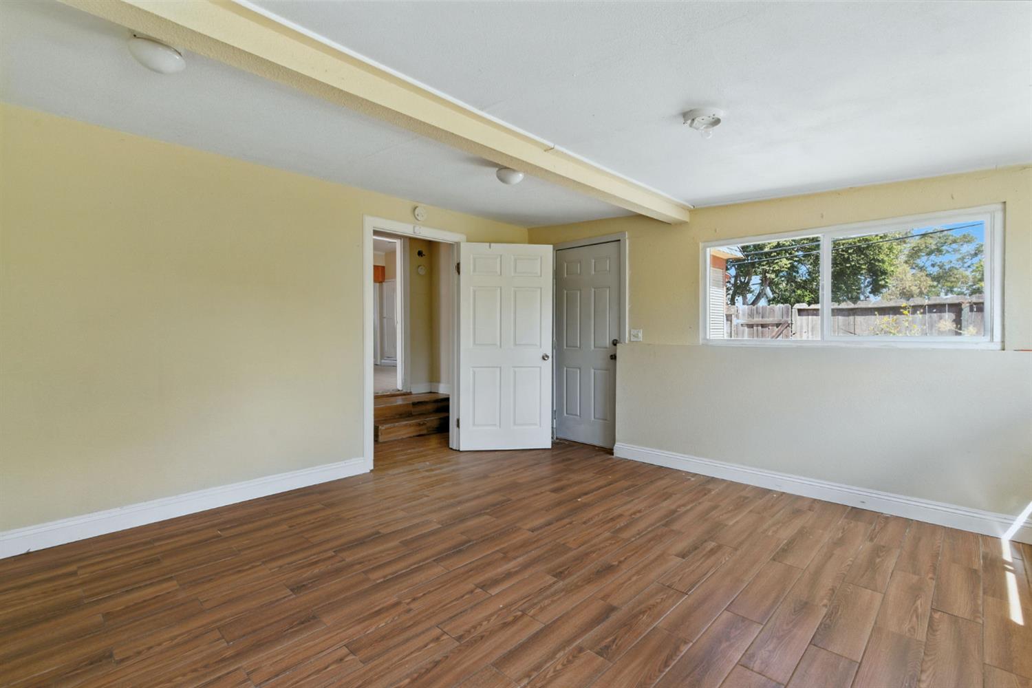 312 West Main Street Turlock, CA 95380 - Photo 31 of 84 a view of an empty room with wooden floor and a window