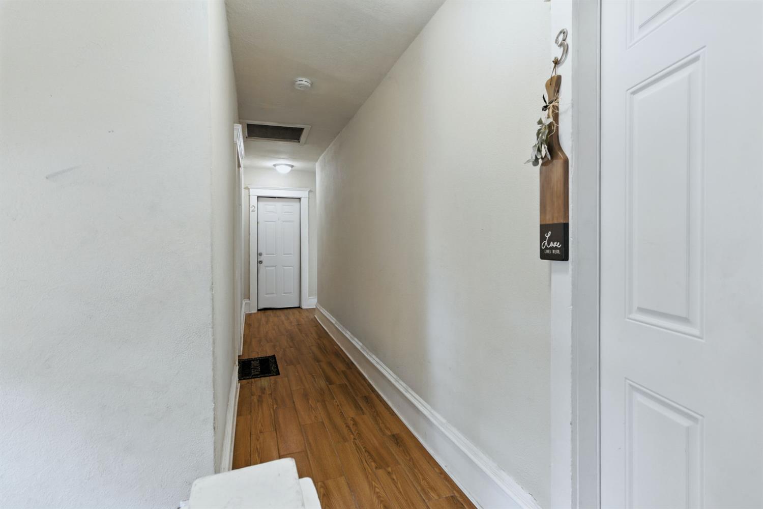 312 West Main Street Turlock, CA 95380 - Photo 32 of 84 a view of a hallway with wooden floor and staircase