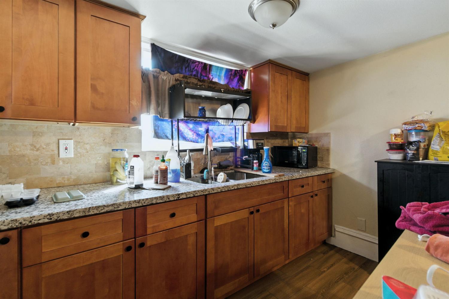 312 West Main Street Turlock, CA 95380 - Photo 36 of 84 a kitchen with stainless steel appliances granite countertop a sink and cabinets