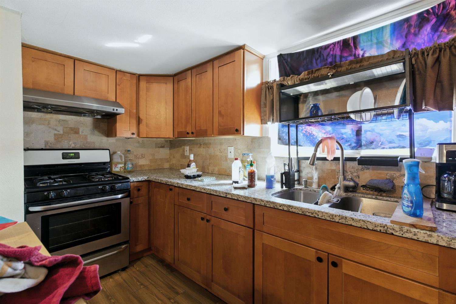 312 West Main Street Turlock, CA 95380 - Photo 37 of 84 a kitchen with stainless steel appliances granite countertop a stove and cabinets
