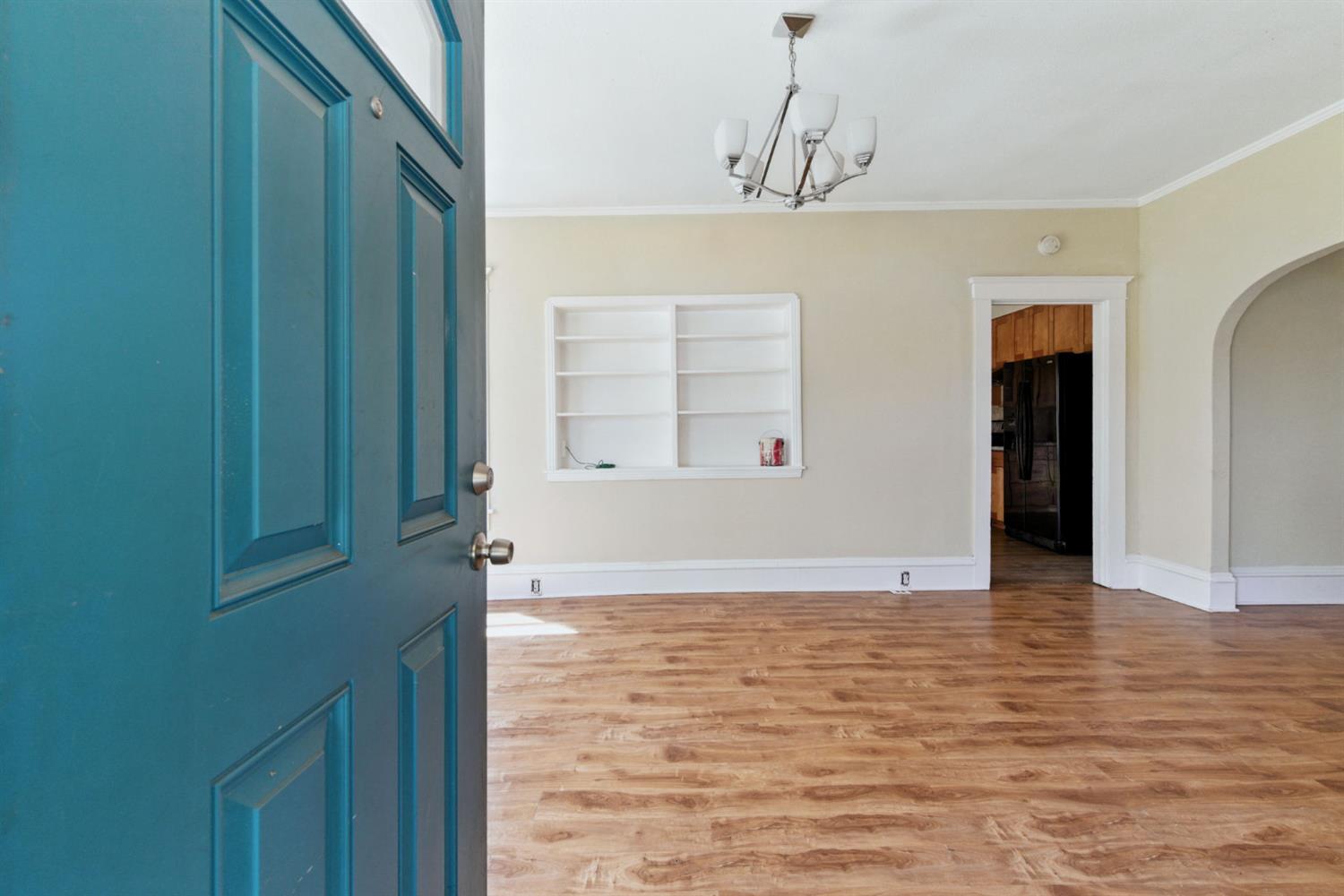 312 West Main Street Turlock, CA 95380 - Photo 9 of 84 a view of an empty room with cabinet and window