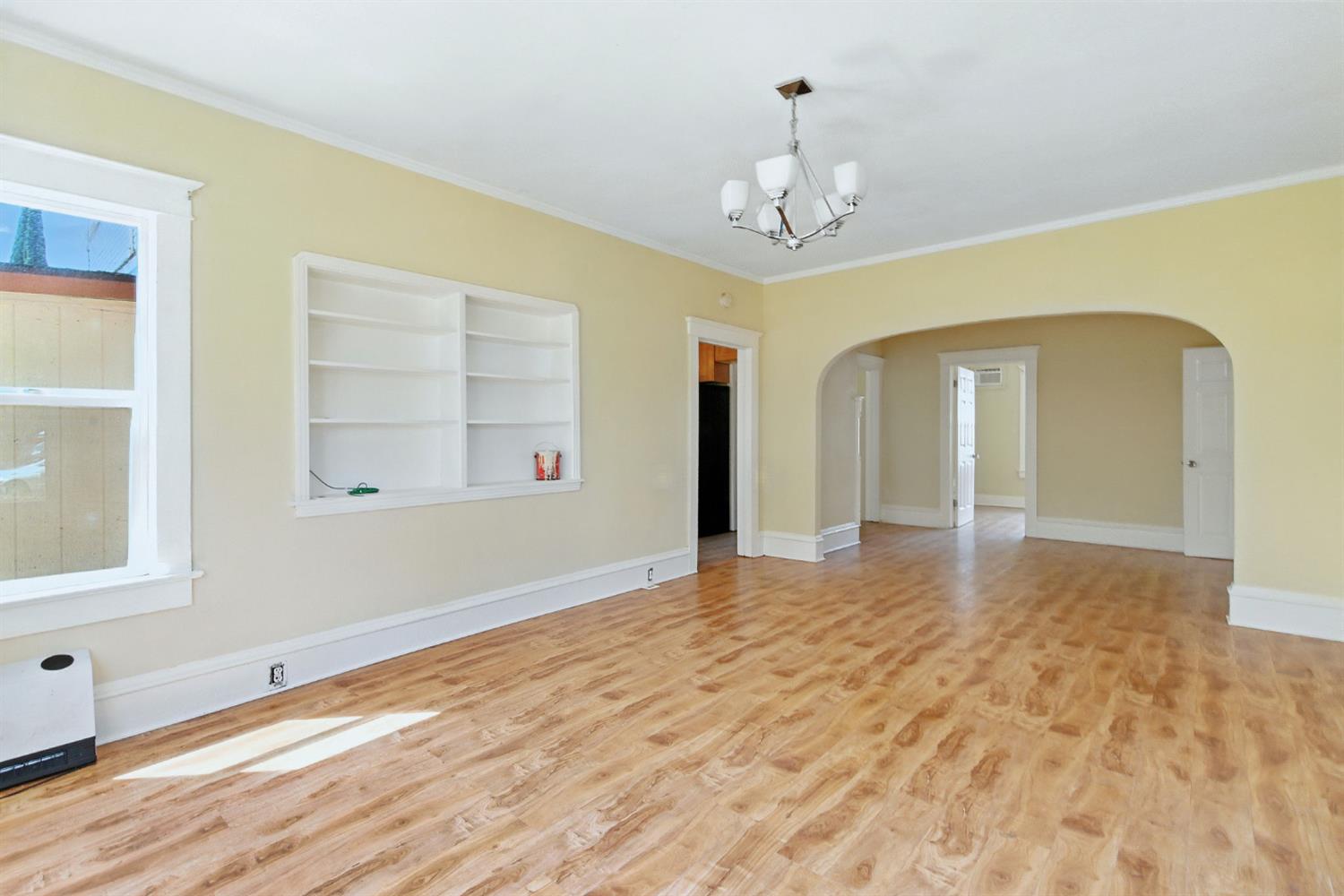 312 West Main Street Turlock, CA 95380 - Photo 10 of 84 a view of an empty room with wooden floor and a window