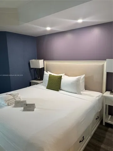 a bedroom with a bed and a night stand