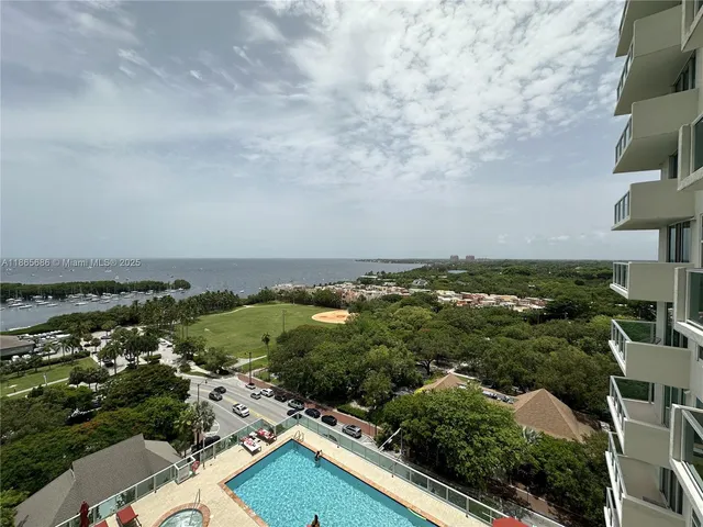 an aerial view of a residential houses with outdoor space and trees