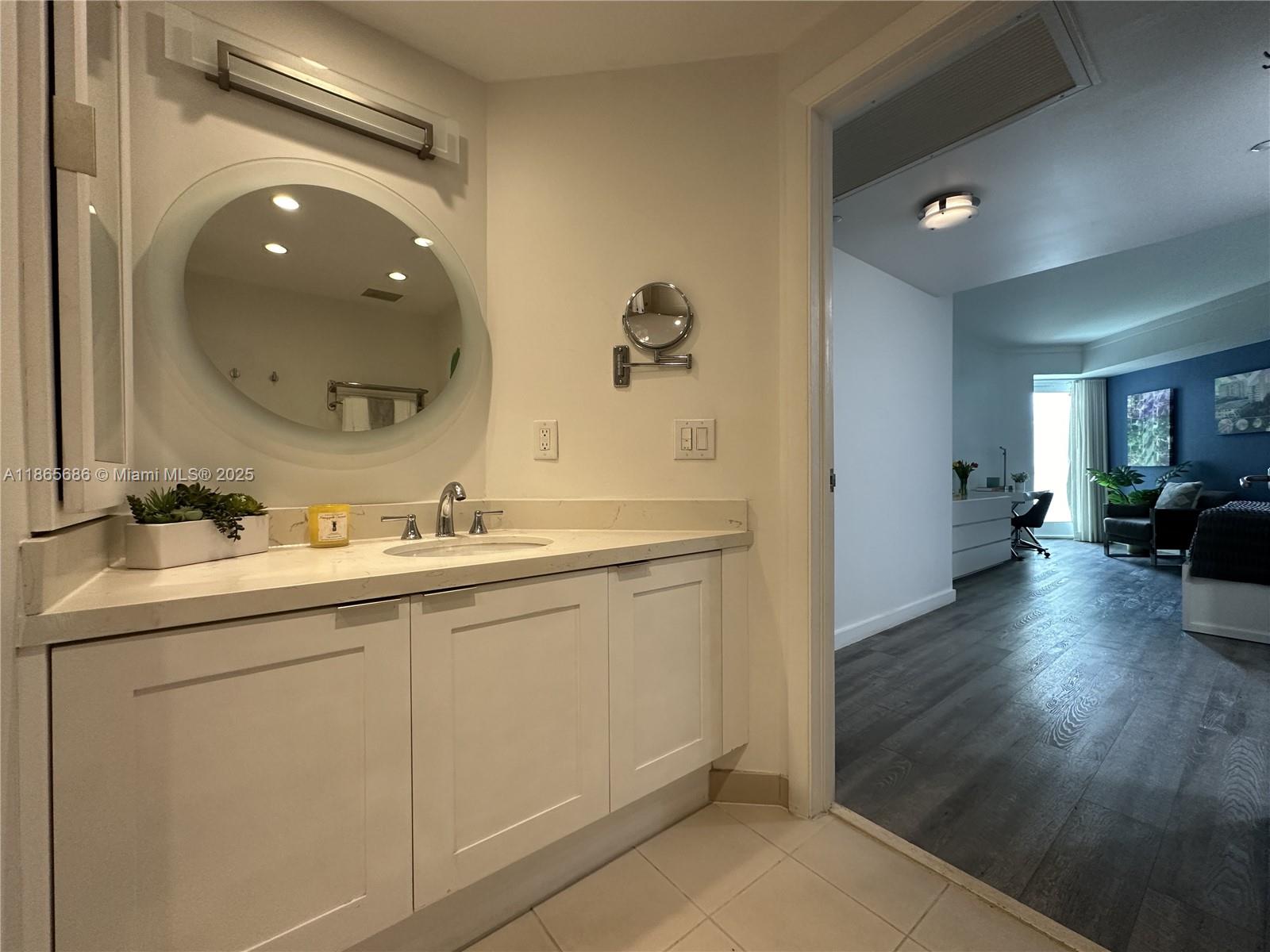 2889 McFarlane Road, Unit 1406 Miami, FL 33133 - Photo 19 of 23 a spacious bathroom with a double vanity sink and a mirror