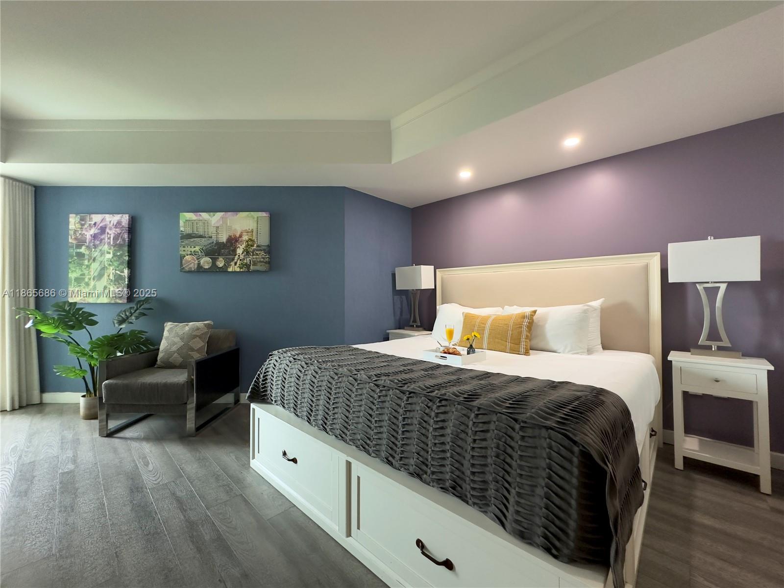 2889 McFarlane Road, Unit 1406 Miami, FL 33133 - Photo 21 of 23 a spacious bedroom with a bed and a couch