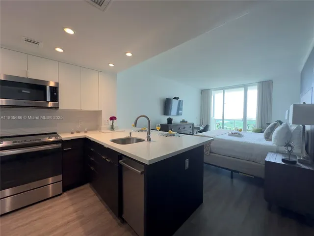 a kitchen with a sink stove and cabinets