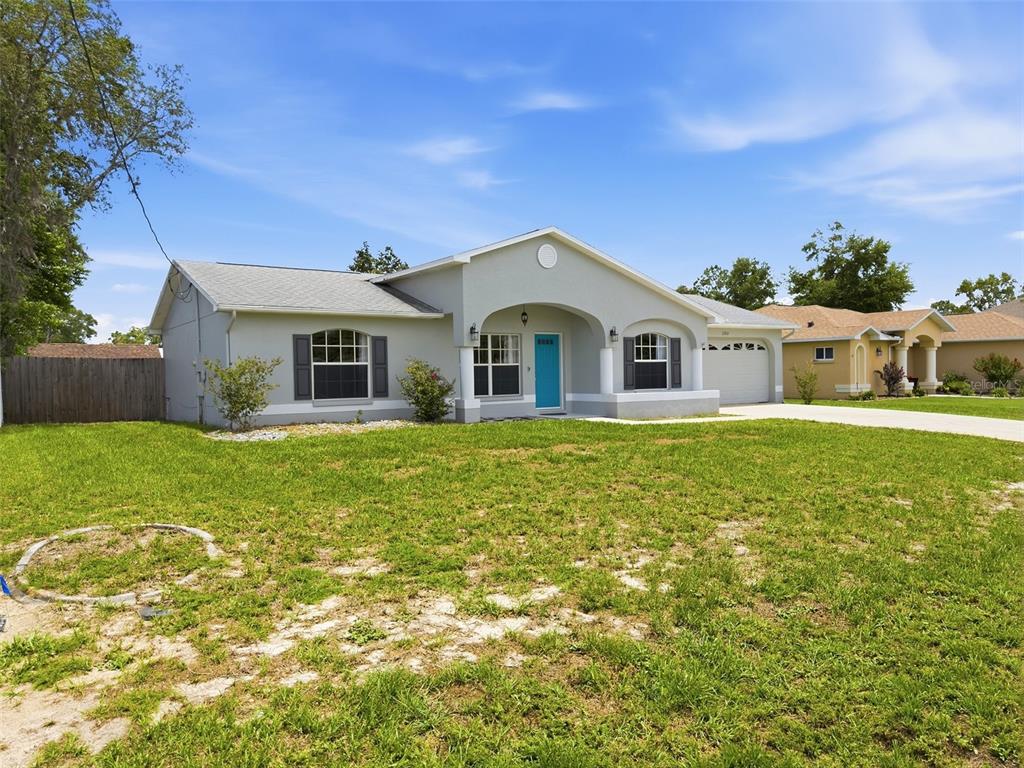 2202 Godfrey Avenue Spring Hill, FL 34609 - Photo 3 of 36 a front view of a house with garden