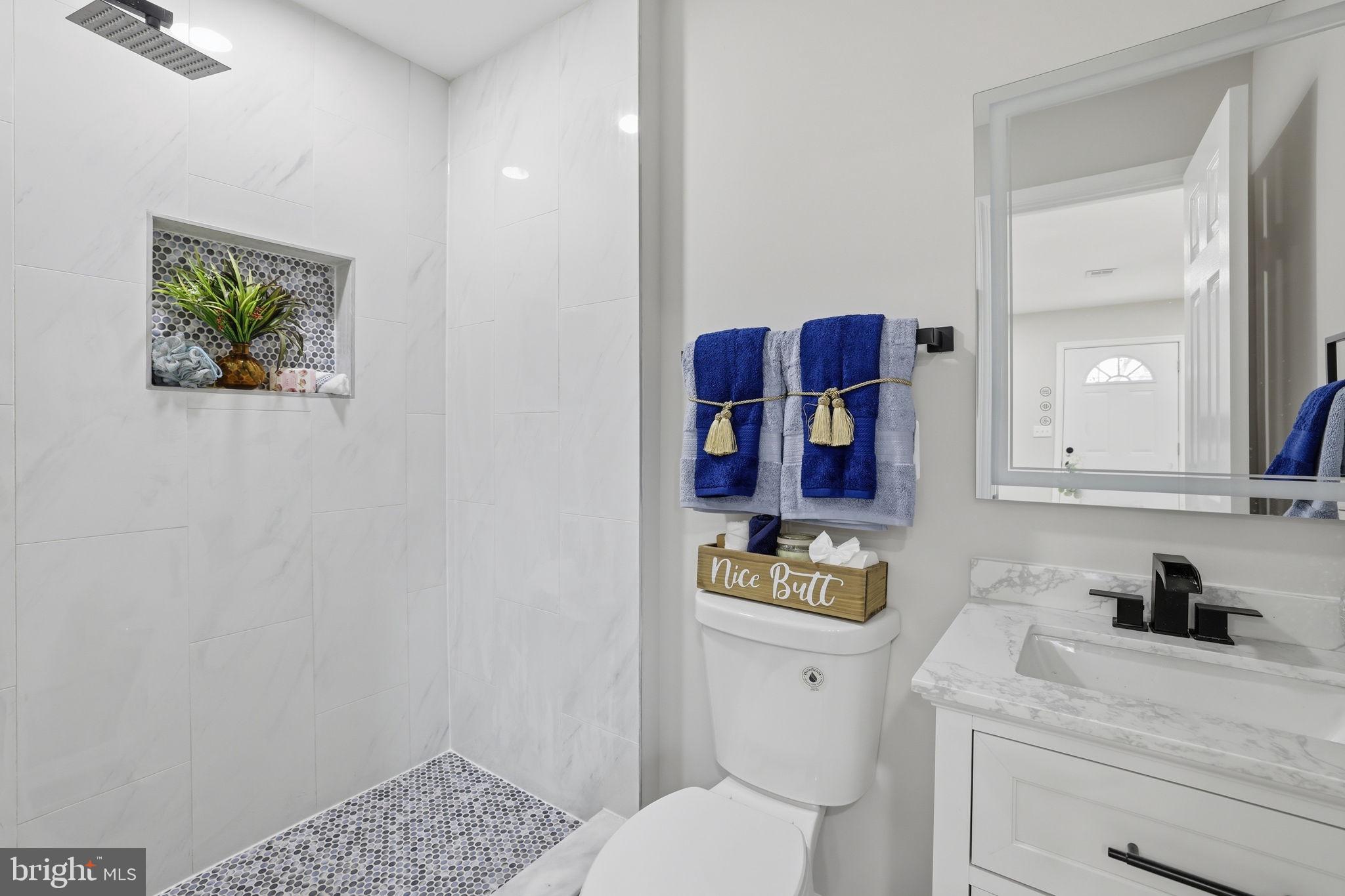 2403 Greeley Place Landover, MD 20785 - Photo 13 of 39 a bathroom with a toilet sink and mirror