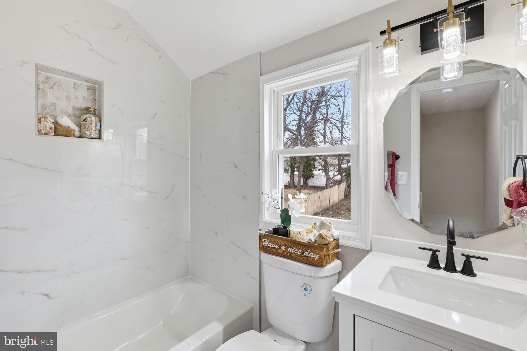2403 Greeley Place Landover, MD 20785 - Photo 19 of 39 a bathroom with a sink a toilet and a mirror