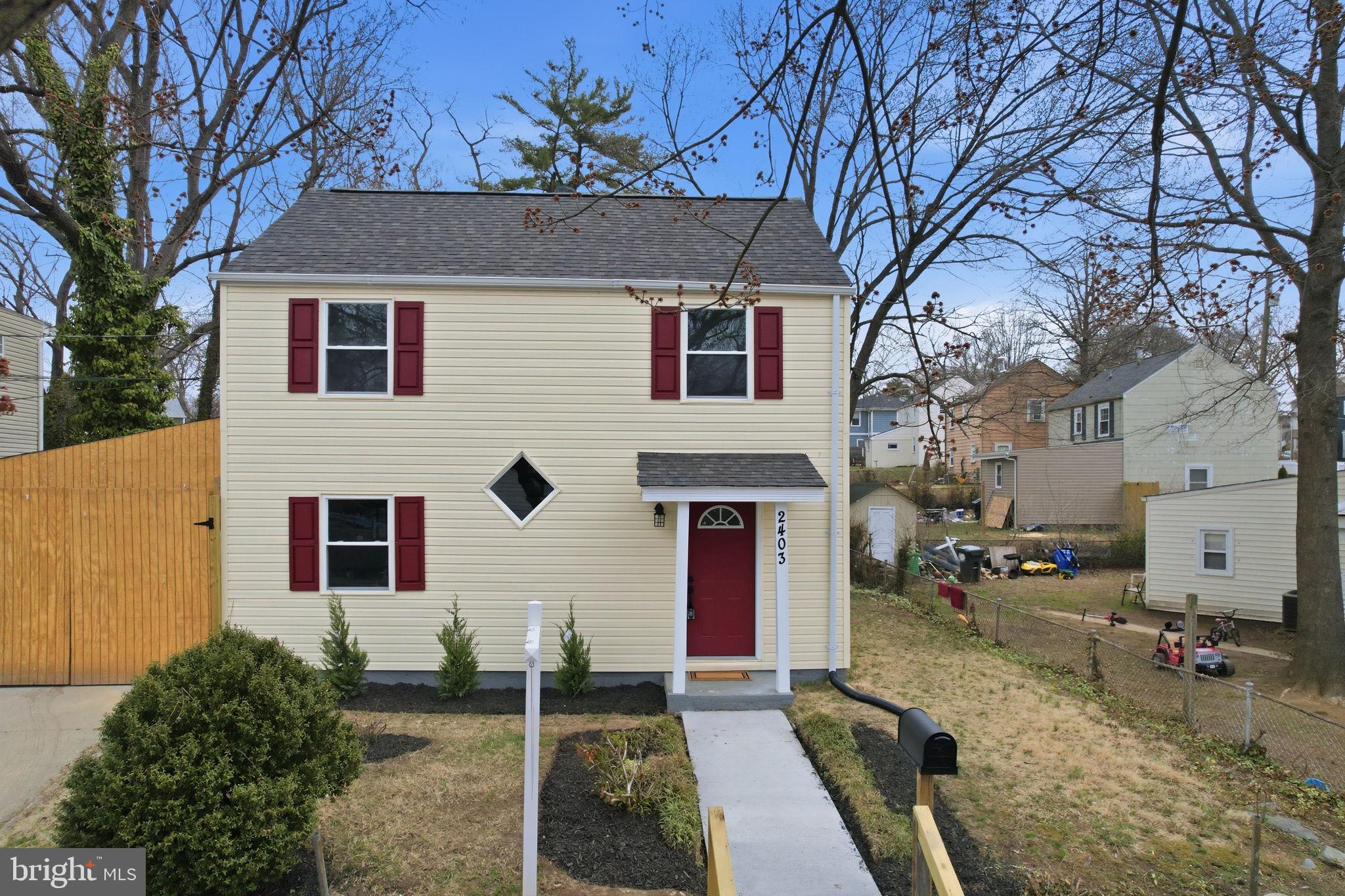 2403 Greeley Place Landover, MD 20785 - Photo 27 of 39 a front view of a house with a yard
