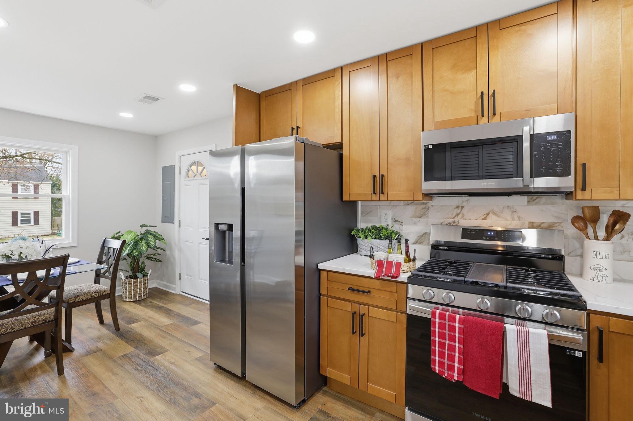2403 Greeley Place Landover, MD 20785 - Photo 5 of 39 a kitchen with stainless steel appliances granite countertop a stove a refrigerator and a microwave