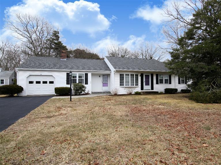 56 James Otis Road Centerville, MA 02632 - Photo 1 of 8 a front view of a house with a yard