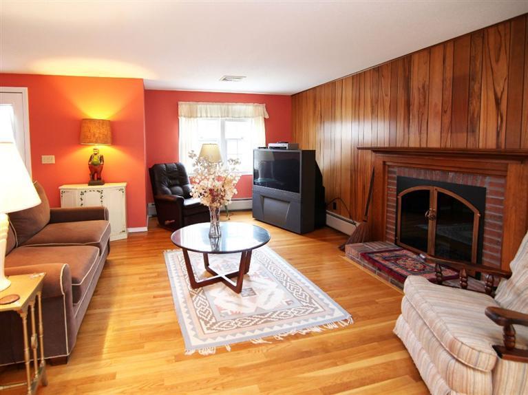 56 James Otis Road Centerville, MA 02632 - Photo 2 of 8 a living room with furniture and a fireplace