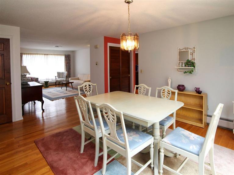 56 James Otis Road Centerville, MA 02632 - Photo 7 of 8 a view of a dining room and livingroom with furniture wooden floor a rug a chandelier
