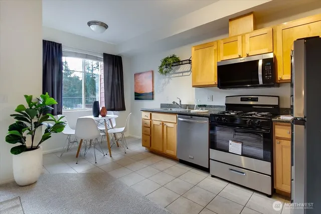 a kitchen with a stove a sink and a microwave