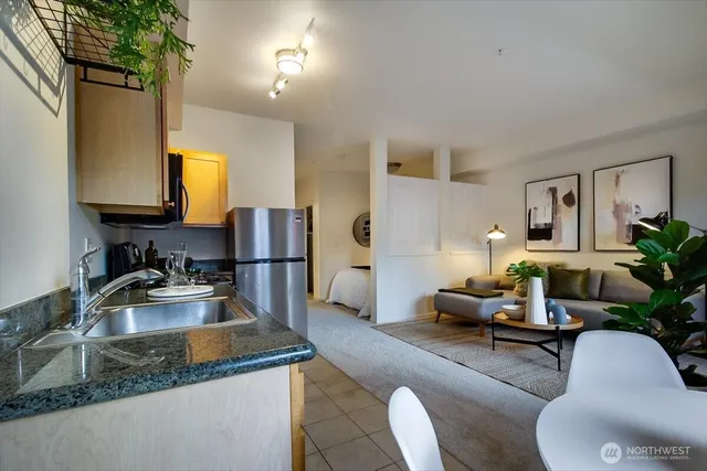 a kitchen with a refrigerator table and chairs