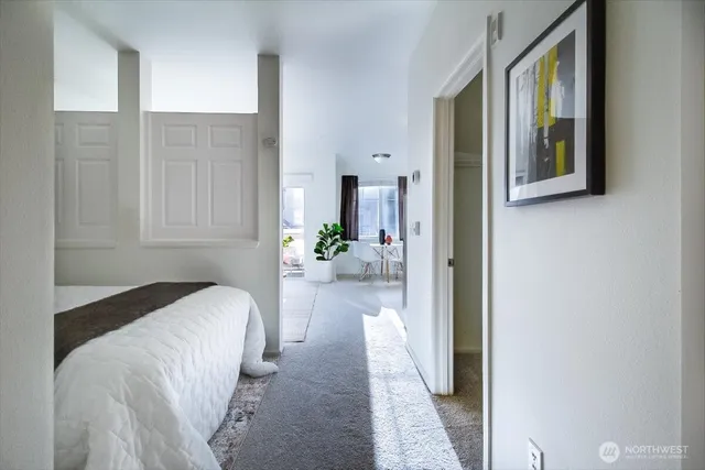 a bedroom with a bed and a potted plant