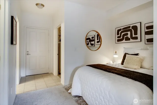 a bedroom with a bed and a wall painting